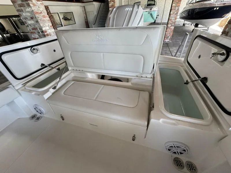 Slide: The Image of 2025 Regulator 24 XO boat interior with open storage compartments and seating. - 6