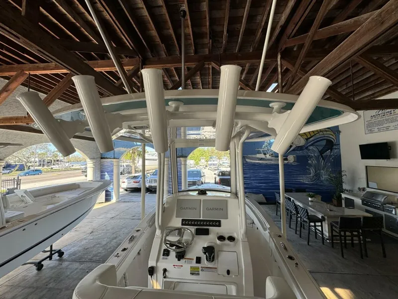 Slide: The Image of 2025 Regulator 24 XO boat interior with rod holders and Garmin electronics. - 8