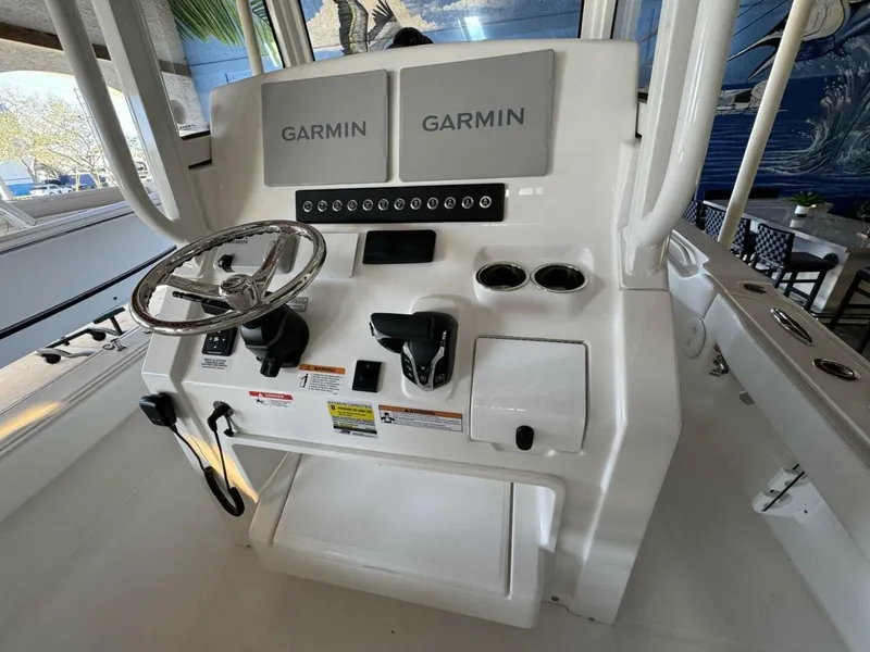 Slide: The Image of 2025 Regulator 24 XO boat console with dual Garmin displays and steering wheel. - 9