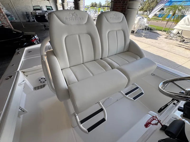 Slide: The Image of 2025 Regulator 26XO boat with dual white cushioned seats and steering wheel. - 11