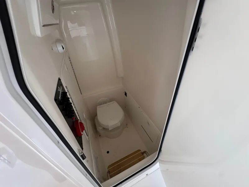 Slide: The Image of 2025 Regulator 26XO boat interior with compact marine toilet. - 14