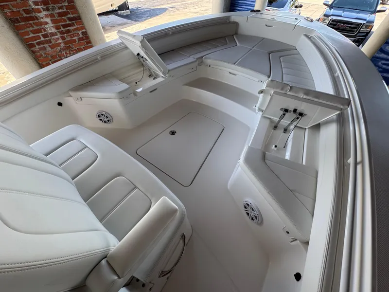 Slide: The Image of 2025 Regulator 26XO boat interior with white seating and storage compartments. - 15