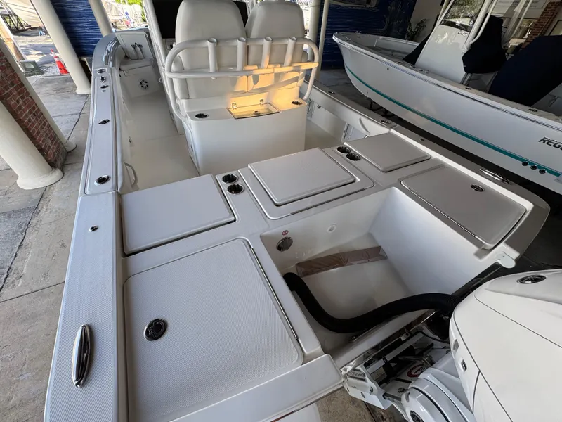 Slide: The Image of 2025 Regulator 26XO boat interior with storage compartments and seating. - 3