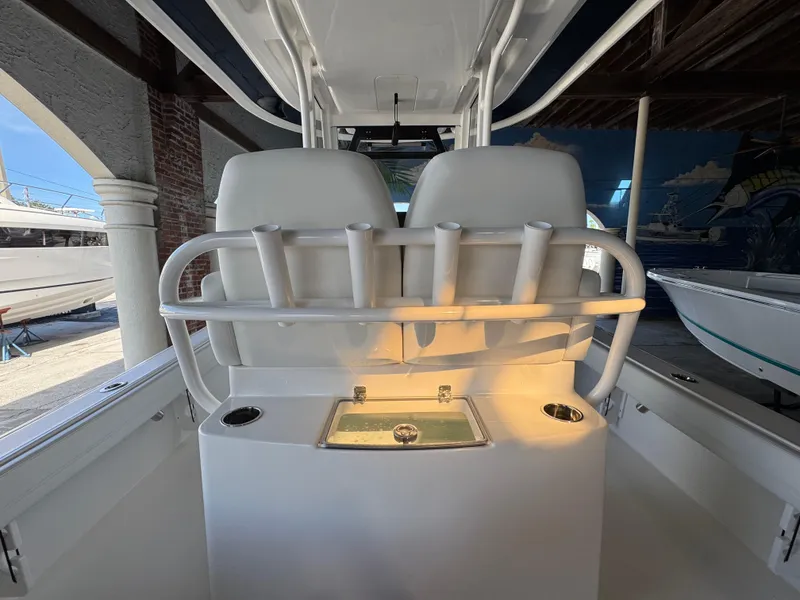 Slide: The Image of 2025 Regulator 26XO boat interior with rod holders and illuminated storage compartment. - 7