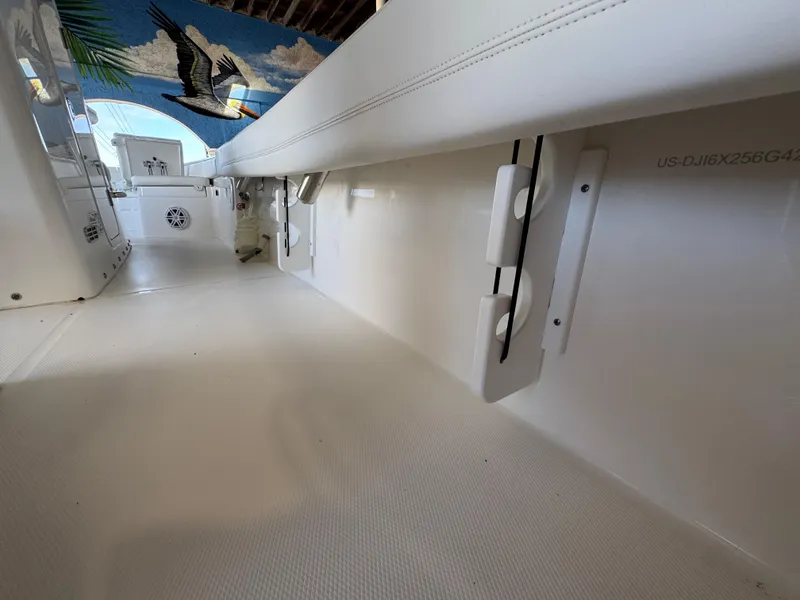 Slide: The Image of 2025 Regulator 26XO boat interior with sleek white design and pelican mural. - 9