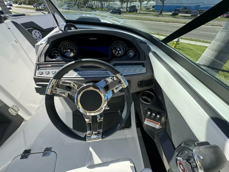 Slide: The Image of 2024 Monterey 255SS boat dashboard with steering wheel and control panel. - 14