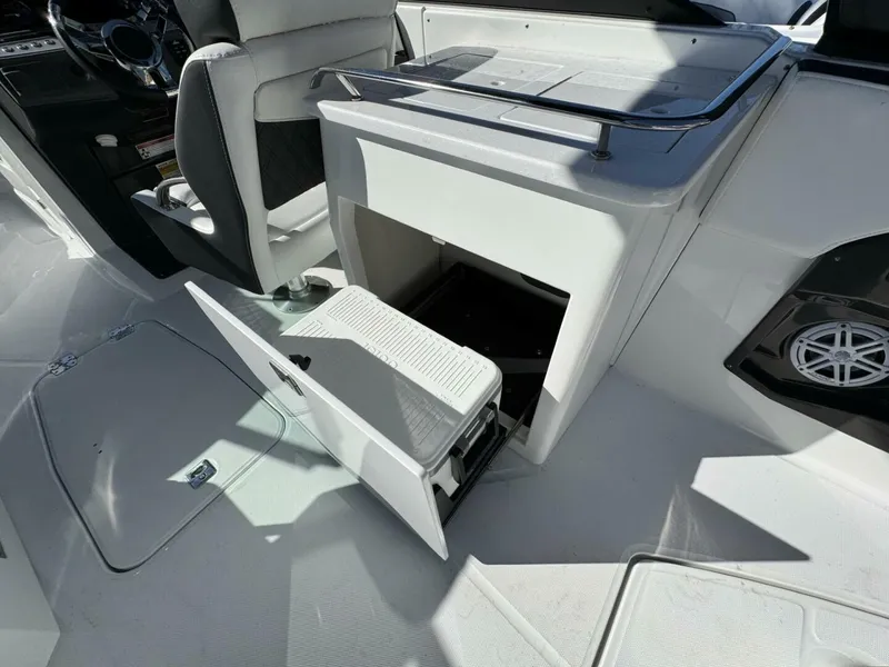 Slide: The Image of 2024 Monterey 255SS boat interior with open storage compartment and seating. - 17