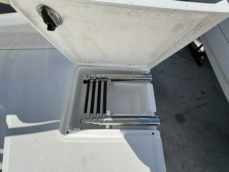 Slide: The Image of 2024 Monterey 255SS boat ladder compartment, open with stainless steel ladder inside. - 3