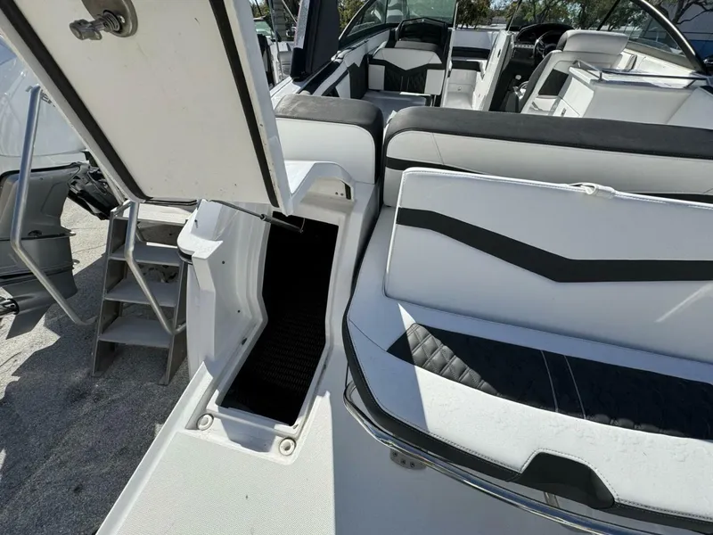 Slide: The Image of 2024 Monterey 255SS boat interior with open storage compartment and seating area. - 5