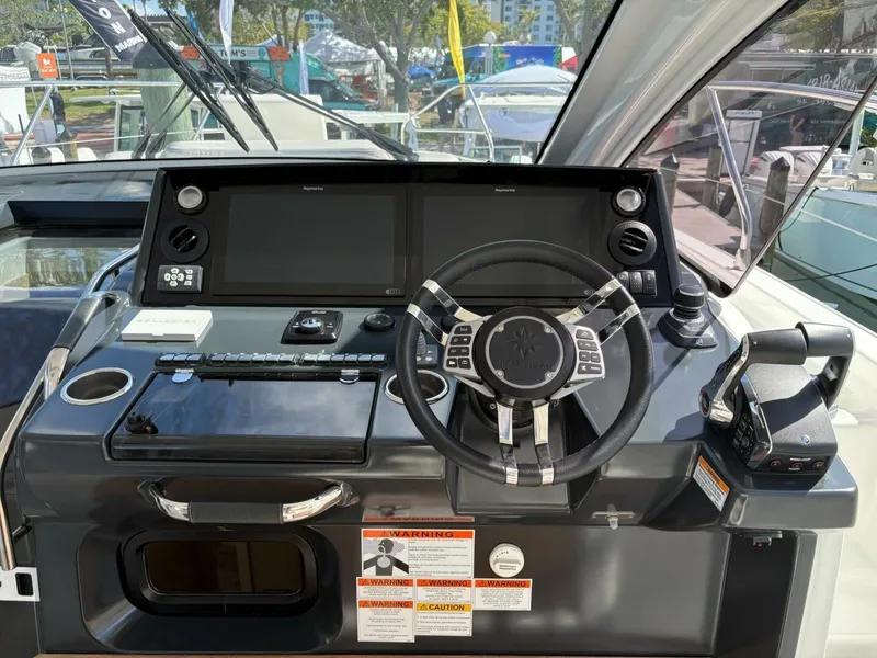 Slide: The Image of 2024 Jeanneau DB43 helm with advanced controls and dual displays. - 11