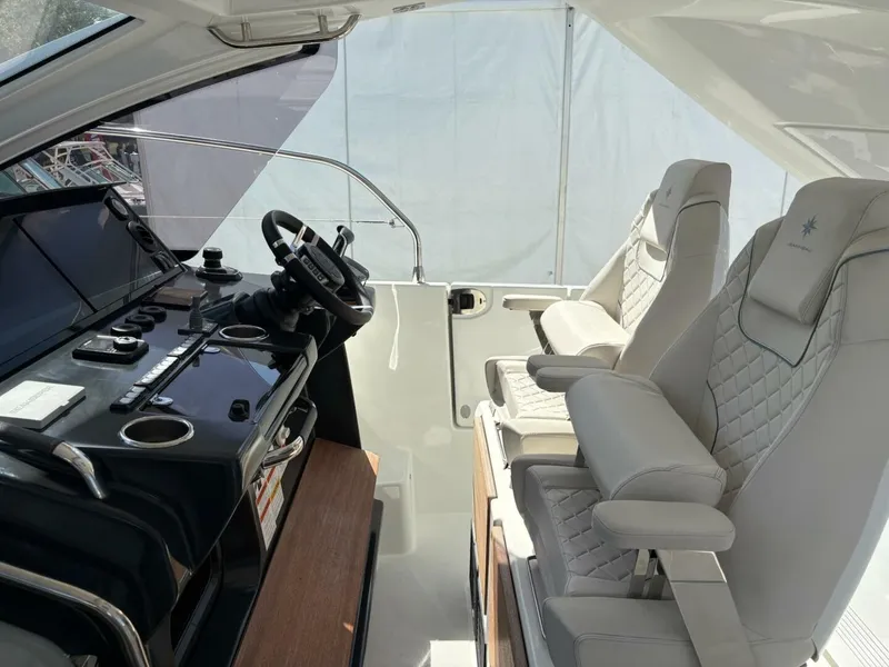 Slide: The Image of 2024 Jeanneau DB43 helm with modern controls and luxurious seating. - 16