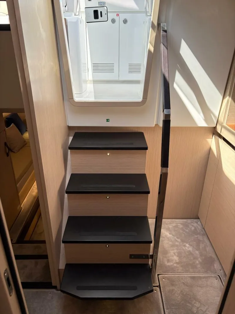 Slide: The Image of Staircase inside 2024 Jeanneau DB43 yacht, featuring sleek design and modern materials. - 18