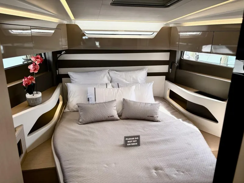 Slide: The Image of Luxurious cabin interior of 2024 Jeanneau DB43 yacht with elegant bedding and decor. - 22