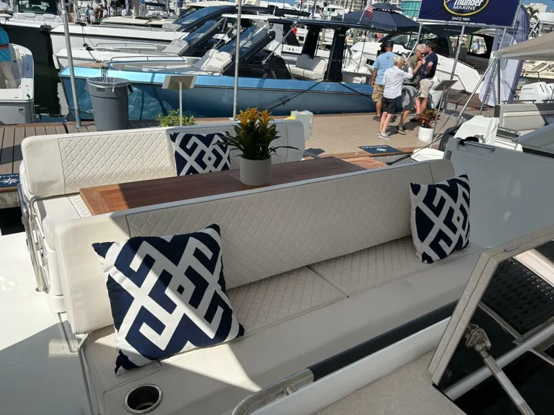 Slide: The Image of Luxurious seating area on 2024 Jeanneau DB43 yacht with decorative pillows and table. - 7