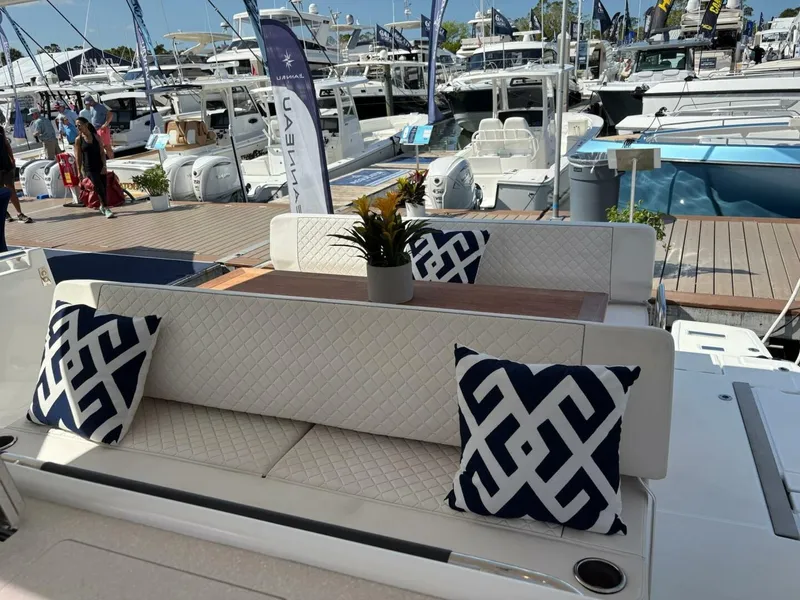 Slide: The Image of 2024 Jeanneau DB43 yacht interior with patterned cushions and elegant seating at a boat show. - 8
