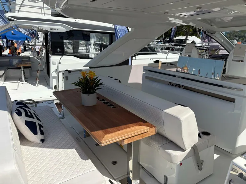 Slide: The Image of 2024 Jeanneau DB43 yacht interior with elegant seating and wooden table. - 9