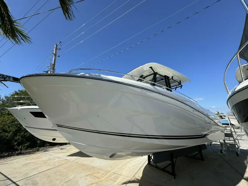 The Image of 2024 Jeanneau 10.5 CC boat on display under clear blue sky. - 0
