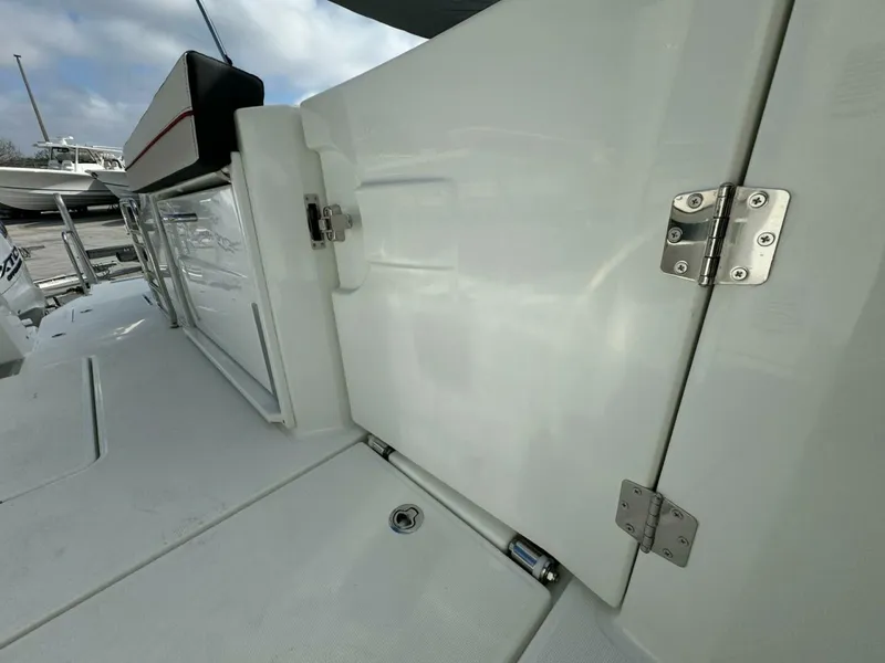 Slide: The Image of 2024 Jeanneau 10.5 CC boat deck with storage compartment and stainless steel hinges. - 14