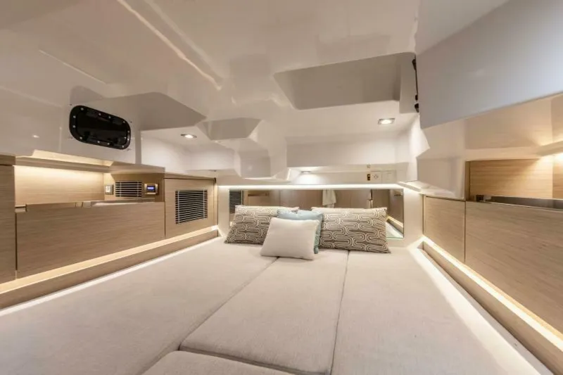 Slide: The Image of Luxurious interior of 2024 Jeanneau 10.5 CC boat with modern design and ambient lighting. - 16
