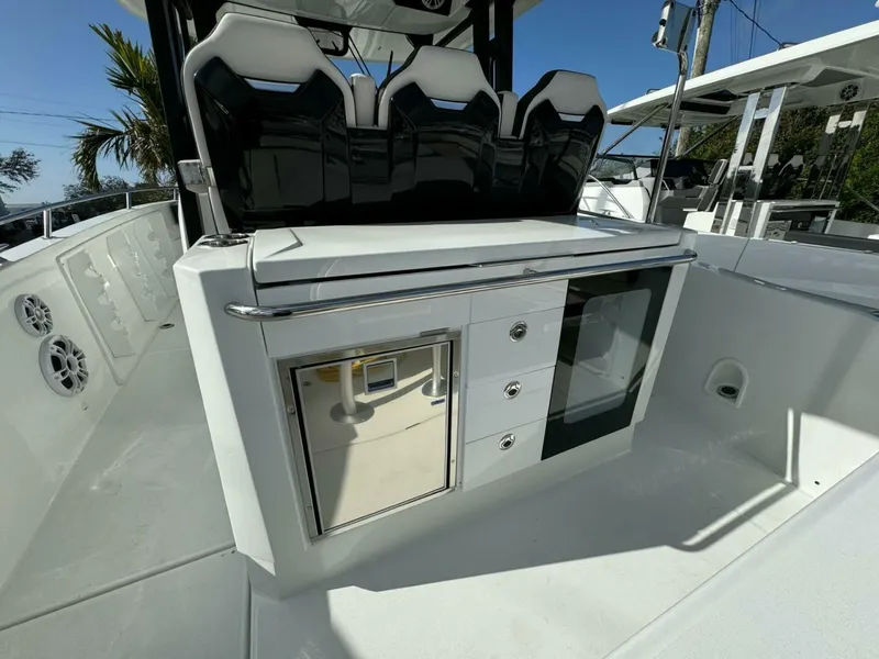 Slide: The Image of 2024 Jeanneau 10.5 CC boat interior with seating and storage compartments. - 4