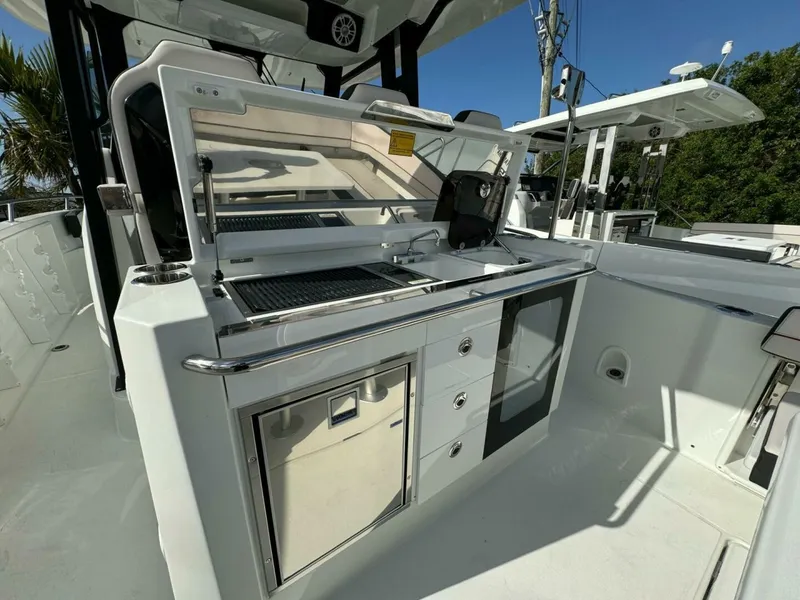 Slide: The Image of 2024 Jeanneau 10.5 CC boat interior with sleek kitchen setup and modern amenities. - 5