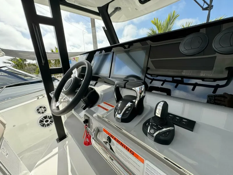 Slide: The Image of Helm of 2024 Jeanneau 10.5 CC boat with modern controls and steering wheel. - 7