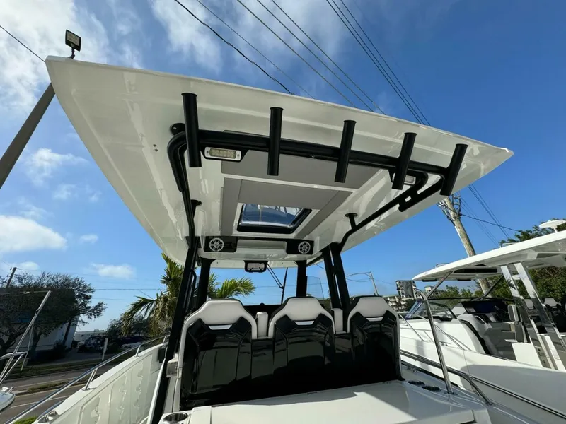Slide: The Image of 2024 Jeanneau 10.5 CC boat with sleek design and modern seating under a clear blue sky. - 8