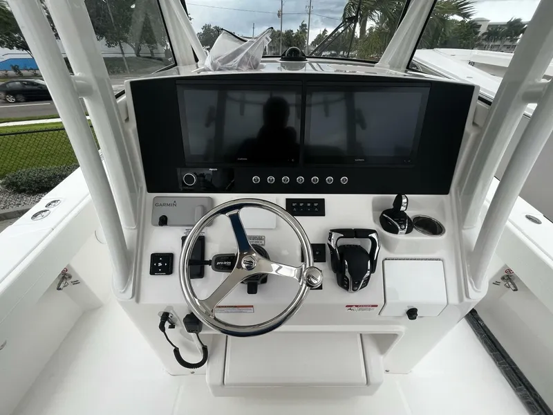 Slide: The Image of 2025 Regulator 30XO boat helm with dual Garmin displays and steering wheel. - 14