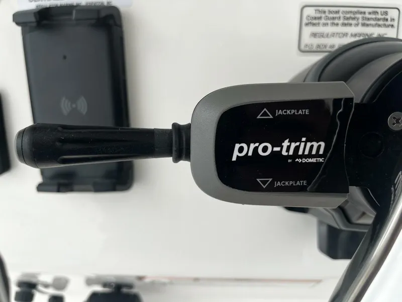Slide: The Image of Pro-trim control lever on 2025 Regulator 30XO boat dashboard. - 19