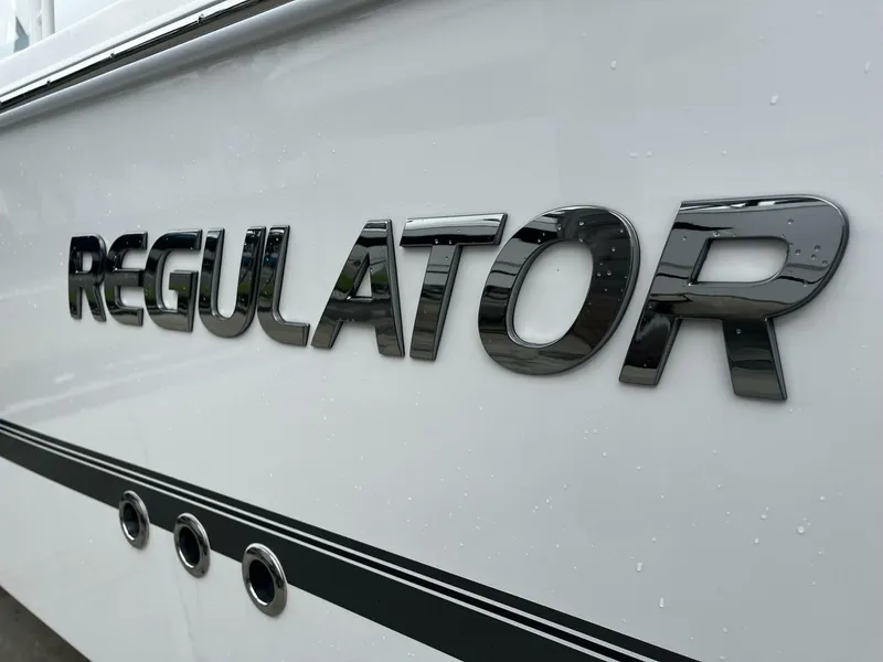 Slide: The Image of Regulator 30XO 2025 boat logo on sleek white hull. - 2