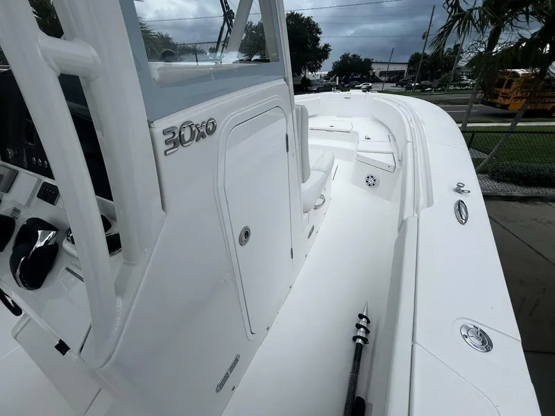 Slide: The Image of 2025 Regulator 30XO boat interior with sleek white design and modern controls. - 21
