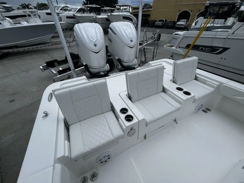 Slide: The Image of 2025 Regulator 30XO boat with white seating and dual outboard engines. - 7
