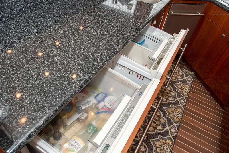 Slide: The Image of Luxury yacht kitchen with granite countertop and open refrigerator drawers, Hatteras 63 Raised Pilothouse, 2002. - 14