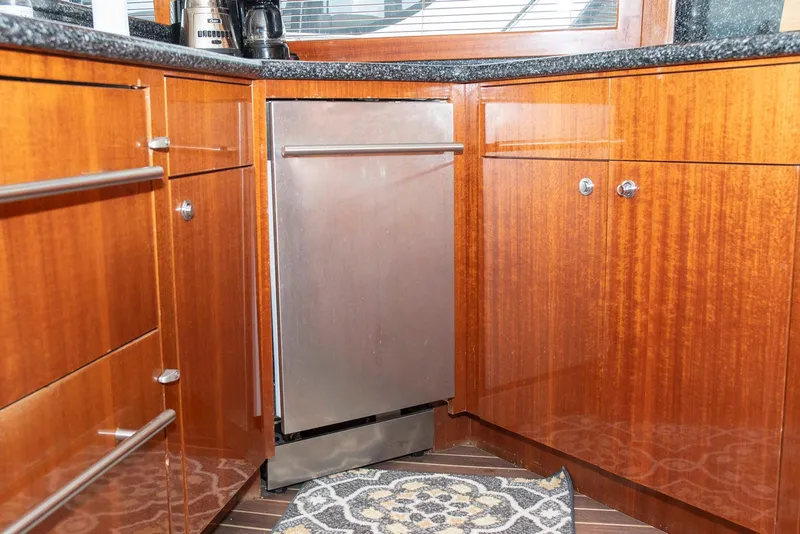Slide: The Image of Wooden yacht kitchen with stainless steel dishwasher, Hatteras 63 Raised Pilothouse Motor Yacht, 2002. - 18