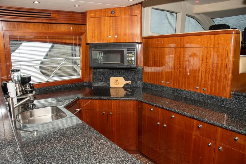 Slide: The Image of Luxurious kitchen in 2002 Hatteras 63 Raised Pilothouse Motor Yacht with wood cabinetry and granite countertops. - 19