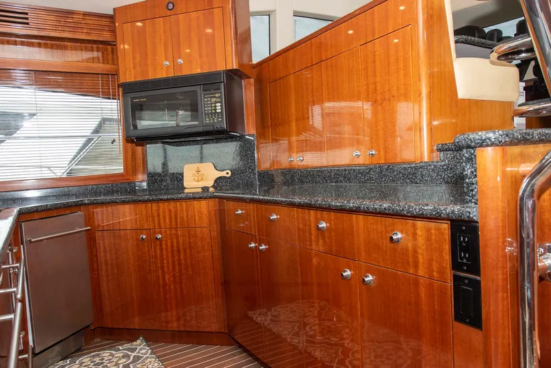 Slide: The Image of Luxurious kitchen in 2002 Hatteras 63 Raised Pilothouse Motor Yacht with wood cabinetry and granite countertops. - 22