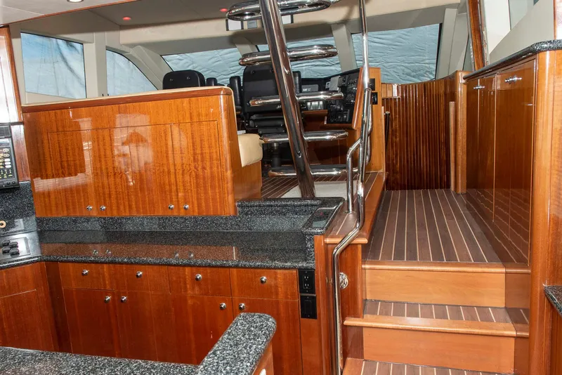 Slide: The Image of Luxurious interior of 2002 Hatteras 63 Raised Pilothouse Motor Yacht with wood finishes. - 23