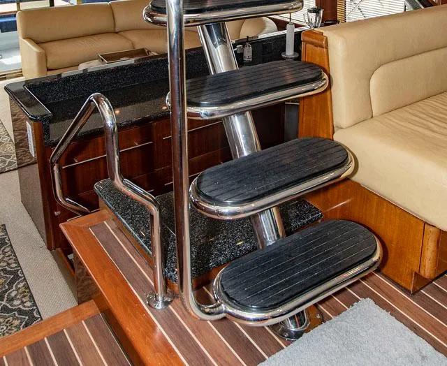 Slide: The Image of Staircase in 2002 Hatteras 63 Raised Pilothouse Motor Yacht interior, featuring wood and metal design. - 24