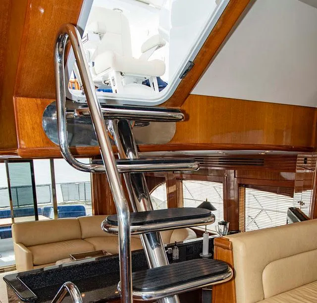 Slide: The Image of Interior of 2002 Hatteras 63 Raised Pilothouse Motor Yacht with sleek metal ladder. - 25