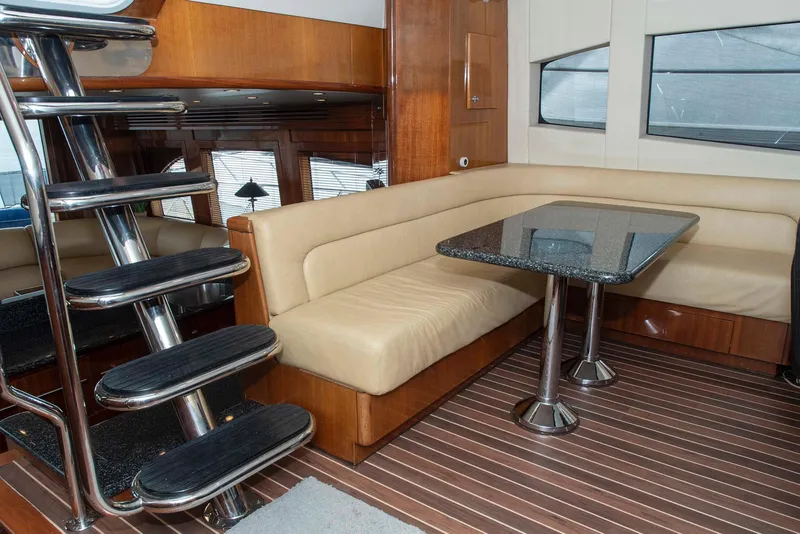 Slide: The Image of Interior of 2002 Hatteras 63 Yacht with modern seating and sleek staircase. - 26