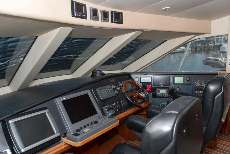 Slide: The Image of Pilothouse of 2002 Hatteras 63 Raised Motor Yacht with navigation equipment and leather seating. - 29