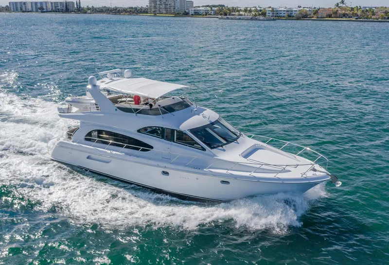 Slide: The Image of 2002 Hatteras 63 Raised Pilothouse Motor Yacht cruising on open water. - 3