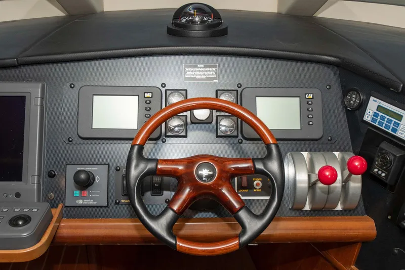 Slide: The Image of Pilothouse of 2002 Hatteras 63 Raised Motor Yacht with wooden steering wheel and control panels. - 30