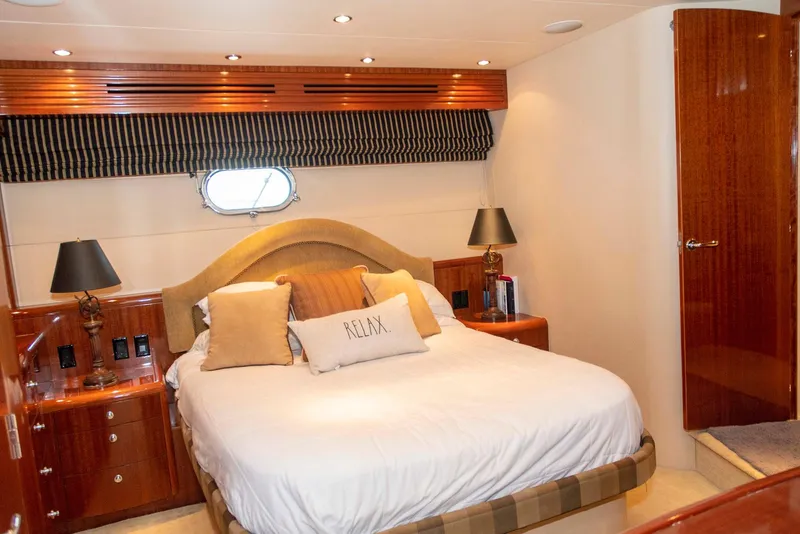 Slide: The Image of Luxurious bedroom in 2002 Hatteras 63 Raised Pilothouse Motor Yacht with elegant wood finishes. - 41