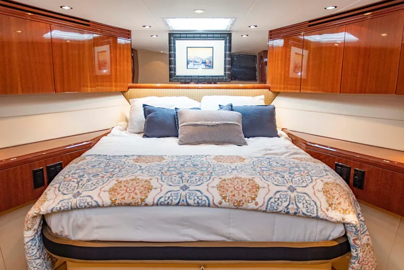 Slide: The Image of Luxurious bedroom in 2002 Hatteras 63 Raised Pilothouse Motor Yacht with elegant wood cabinetry. - 48