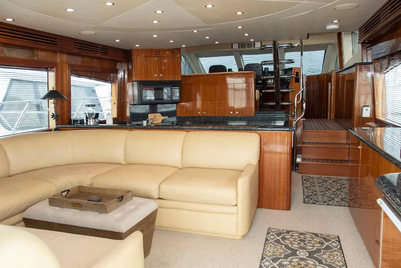 Slide: The Image of Luxurious interior of 2002 Hatteras 63 Raised Pilothouse Motor Yacht with leather seating and wood finishes. - 5