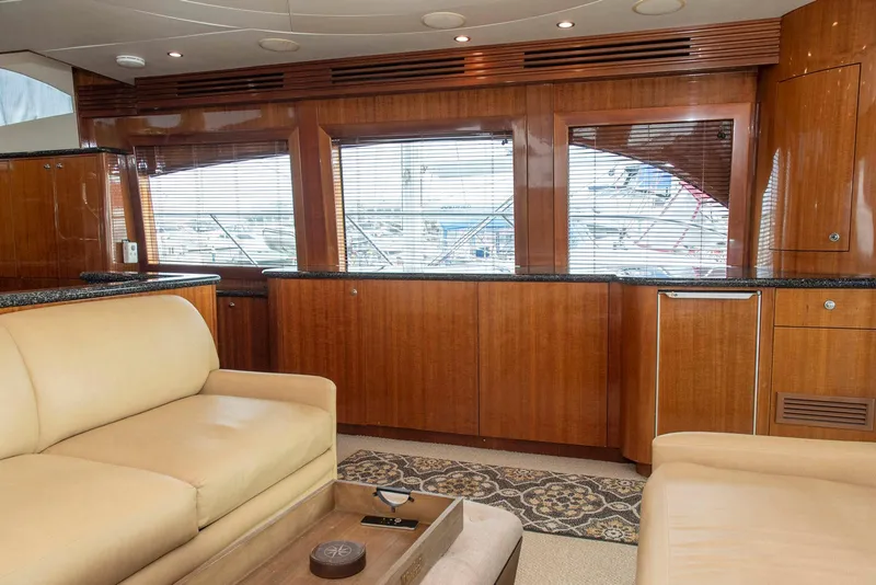 Slide: The Image of Luxurious interior of 2002 Hatteras 63 Raised Pilothouse Motor Yacht with wood paneling and leather seating. - 9