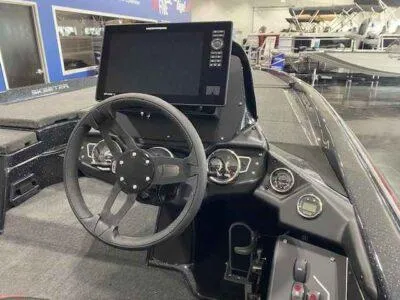 Slide: The Image of Cockpit of 2025 Skeeter ZXR 21 boat with steering wheel and digital display. - 4