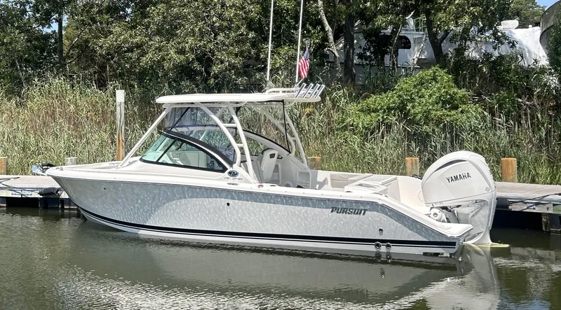 The Image of 2026 Pursuit DC 246 Dual Console boat docked with Yamaha engine. - 0