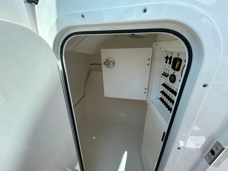 Slide: The Image of 2026 Pursuit DC 246 Dual Console interior with control panel and storage compartment. - 21